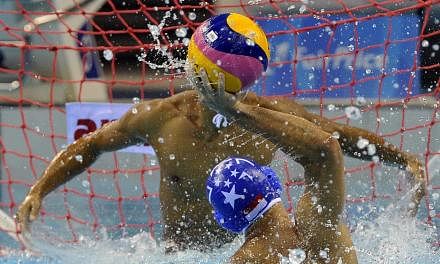 Singapore's Chiam Kunyang (No. 7) attempting to score against his Filipino opponent in their men's water polo match at the OCBC Aquatic Centre on June 14, 2015. -- PHOTO: SINGAPORE SEA GAMES ORGANISING COMMITTEE/ACTION IMAGES VIA REUTERS