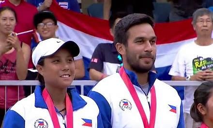 Denise Dy (left) and Treat Huey of the Philippines after receiving their gold medals for winning the tennis mixed doubles at the SEA Games. The victory by Dy and Huey prevented the Thais from getting a clean sweep of all the tennis golds at the games