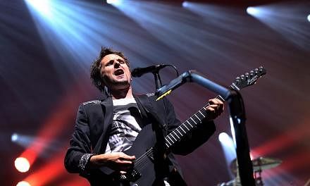 Matthew Bellamy of British rock band &nbsp;Muse performs at the Olympia concert hall in Paris. -- PHOTO: AFP