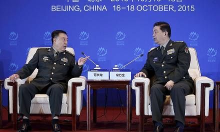 China's Central Military Commission vice-chairman Fan Changlong (left) speaking to Chinese Defence Minister Chang Wanquan at the Xiangshan Forum in Beijing last Saturday. The forum drew around 500 participants from some 60 countries, including 14 def