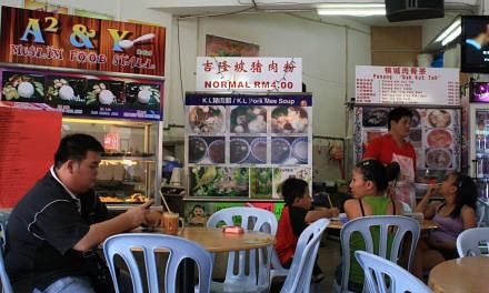 A coffee shop in Sibu, Sarawak, where a Muslim food stall stands beside a pork mee soup stall and another selling bak kut teh (pork rib soup).