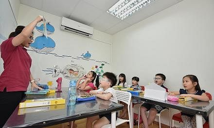 Sprightly Learning Campus co-founder Jolyn Low uses flash cards during a maths lesson for six-year-olds (from left) Leow Hui Yu, Cayern Se, Alecia Tan, Koay Ger Maine, Isaac Lim and Isabell Tan.