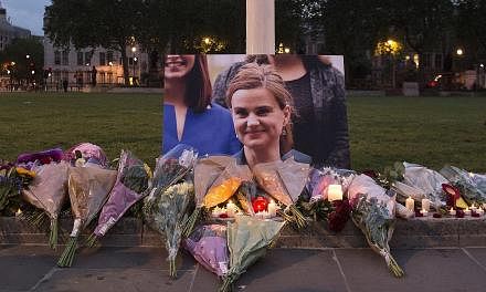 Floral tributes left in memory of Mrs Cox in Parliament Square, London, on Thursday. Mr Cameron has recalled Parliament on Monday to pay tribute to her.