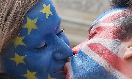 A couple with their faces painted in the flags of the European Union and Britain kissing in Berlin on Sunday. Similar action took place in several cities in Europe, with the aim of encouraging the British to vote in favour of remaining in the EU.