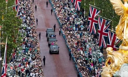 The crowd along the Mall in London cheering the Queen on her official 90th birthday on June 12. 