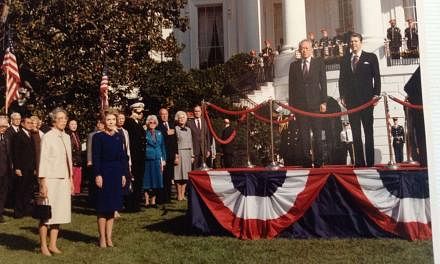 Then PM Lee Kuan Yew with then President Reagan at the ceremonial welcome on the White House lawn before the state dinner on Oct 8, 1985. With them are Mrs Lee, Mrs Reagan, then Secretary of State George Shultz (third from right on the lawn) and then Vice