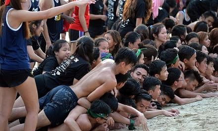 NTU undergraduates taking part in orientation activities at Silosa Beach on Sentosa on Friday. Freshmen who have attended university camps in the last two months say the bulk of activities usually involve team-building games. Those involving physical