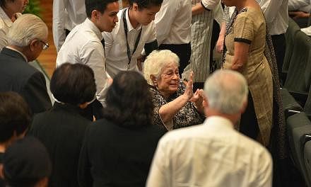 Mrs Nathan waving to attendees as she left the University Cultural Centre auditorium yesterday. The 87-year-old has been hailed as the anchor for Mr Nathan. As PM Lee put it in the most poignant line in his eulogy for Mr Nathan: "The central and brig