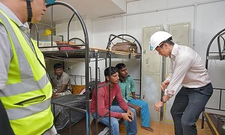 Mr Teo talking to workers in the dormitory at the Sims Urban Oasis construction site yesterday. Thirty-seven cases of Zika were discovered over the weekend to have originated from the site, and another two surfaced on Monday. A stop-work order was is