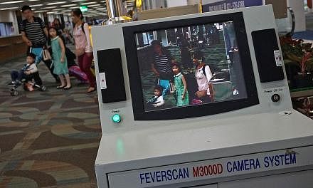 A scanner being used to detect people with fever at Soekarno Hatta International Airport in Tangerang, on the outskirts of Jakarta, yesterday. Fever is one of the symptoms of Zika infection. Other symptoms include an itchy rash, body aches and red ey