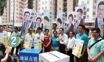 Five generations of Democratic Party chairmen, including (from left) Mr Yeung Sum (in yellow shirt), Ms Emily Lau (in red), Mr Albert Ho, Mr Martin Lee and Mr Lee Wing Tat, turned up to support the party's young contenders on the eve of polling day.