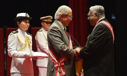 Mr Nathan receiving the Order of Temasek (First Class) from President Tan in 2013. As Prime Minister, Mr Lee has worked closely with two elected presidents, Mr Nathan and Dr Tan.