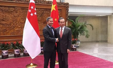 Foreign ministers Dr Balakrishnan and Mr Wang meeting in Beijing yesterday on the sidelines of the Joint Council for Bilateral Cooperation.