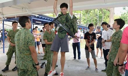 A pull-up challenge at a booth set up by the Singapore Artillery during Yishun JC’s annual Celebrating Values Day. Yishun and Innova JCs, which will be merged, are committed to authentically and meaningfully preserving the heritage of both colleges.