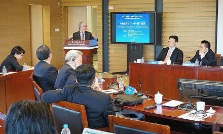 Professor Tommy Koh speaking at the forum yesterday, joined by (from right) China Institute of International Studies vice-president Ruan Zongze and Chongqing Connectivity Initiative deputy director Peng Zhiming.