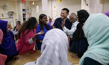 Chua Chu Kang GRC MP Zaqy Mohamad (in blue) with Mr Haja Maideen, executive director of Little Dolphins Playskool, and his pre-school teachers at an iftar session at PCF Sparkletots Preschool in Keat Hong Close yesterday. Mr Zaqy said it was unfair t