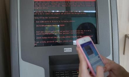 A ransom message popping up on a monitor of a payment terminal at a branch of Ukraine's state-owned bank Oschadbank after institutions were hit by a wave of cyber attacks yesterday. The new virus, which is spreading to many countries, has a fake Micr