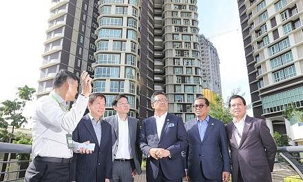 Touring the Afiniti Medini mixed-use development in Iskandar Puteri yesterday were (from second left) ministers Khaw Boon Wan and Lawrence Wong, with Malaysia's Minister in the Prime Minister's Department Abdul Rahman Dahlan, Johor Menteri Besar Moha