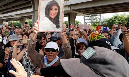 Above: Former commerce minister Boonsong Teriyapirom was sentenced to 42 years in jail yesterday for faking a government- to-government sale deal involving rice from state stockpiles. Left: Supporters of ousted former Thai prime minister Yingluck Shi