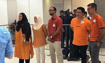 Above: With Madam Halimah at the nomination centre yesterday were (from left) daughter Sharifah Bahiyah, daughter-in-law Amal Nasibah, son Syed Isa, son-in-law Mohd Karno and son Syed Ali. Left: The crowd showing their support for the President-elect