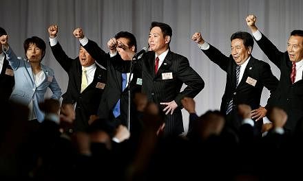 Mr Seiji Maehara with party members after they picked him to lead the Democratic Party, Japan's main opposition group, on Sept 1. Now, DP members say they would rather run as independents than back his tie-up with Kibo no To.