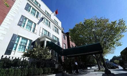 Above: The Singapore flag flying over historic Blair House, where Prime Minister Lee Hsien Loong is staying as a guest of the US government. This is the third time he is staying at the US President's guest house. Right: PM Lee arriving at Blair House