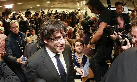 Dismissed Catalonian regional president Carles Puigdemont arriving at the Press Club in Brussels yesterday. He is in Belgium in an effort to evade arrest on charges of sedition filed against him back home in Spain.