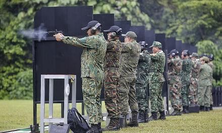 Deputy army chiefs and senior officers from Asean armies firing pistols during the 27th Asean Armies Rifle Meet opening ceremony at Nee Soon Range yesterday. Besides the rifle meet, annual meetings for Asean army chiefs and sergeant majors will take 