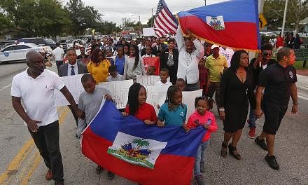 Marchers in the Little Haiti neighbourhood of Miami marking the eighth anniversary of the Haitian earthquake last Friday - and protesting against US President Donald Trump's remarks about Haiti. Mr Trump's vulgar comments last Thursday at an Oval Off