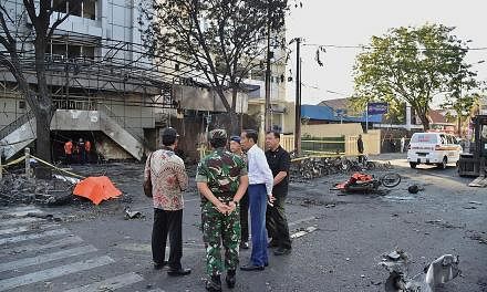 President Joko Widodo (second from right) visiting the scene of a suicide blast outside the Surabaya Centre Pentecostal Church.