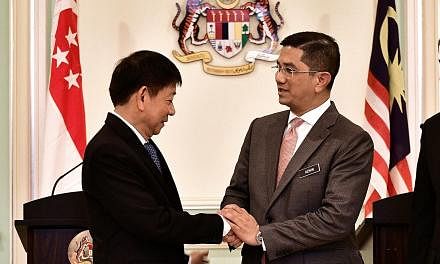 Transport Minister Khaw Boon Wan and Malaysian Economic Affairs Minister Mohamed Azmin Ali at a news conference on Wednesday after the high-speed rail signing ceremony in Putrajaya. The official joint statement after the agreement to pause the projec