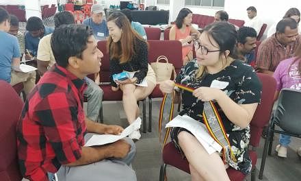 Participants at a Lingua Singapura session where they are paired up to learn their partner's native language.