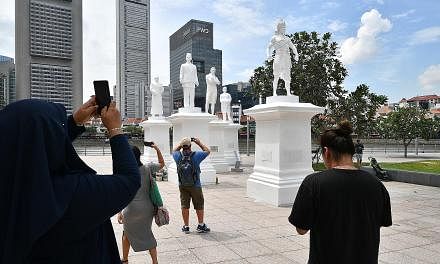 The statue of Sir Stamford Raffles (centre) by the Singapore River has been joined by (from left) community leader Tan Tock Seng, Raffles' secretary and interpreter Munshi Abdullah, treasury chief clerk Naraina Pillai and Sang Nila Utama.