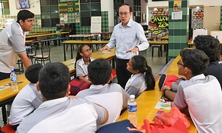 Mr Tan Chor Pang, principal of Boon Lay Secondary School, with some of its students. During his 35 years as an educator, he has taught students from both the Normal and Express streams and has never minded teaching weaker children, saying: "I felt li