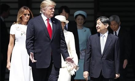 US President Donald Trump and Japan's Emperor Naruhito at a welcome ceremony at the Imperial Palace in Tokyo yesterday. At the imperial banquet, the Emperor spoke about his sense of nostalgia and closeness with the US. PHOTO: BLOOMBERG US First Lady 