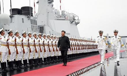 Chinese President Xi Jinping reviewing the guard of honour from the People's Liberation Army Navy last month in Qingdao, Shandong province. The country's military delegation to this year's Shangri-La Dialogue includes two senior officers with experie