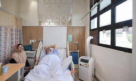 A portable air-conditioning unit and an air purifier (blue) providing ventilation at Alexandra Hospital this month. The Ministry of Health has reminded hospitals, polyclinics and nursing homes "to put in place haze-preparedness measures".