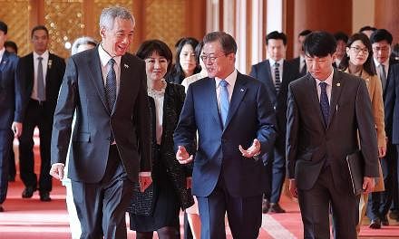 Prime Minister Lee Hsien Loong with South Korean President Moon Jae-in at Seoul's presidential Blue House yesterday, where the two leaders witnessed the signing and exchange of cooperation pacts in standards and conformance, manufacturing of pharmace