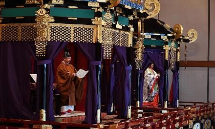 Emperor Naruhito delivering a speech at his enthronement ceremony with Empress Masako at the Imperial Palace in Tokyo on Oct 22. PHOTO: AGENCE FRANCE-PRESSE