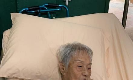 Madam Yap Lay Hong enjoying durian puffs yesterday, a day after her discharge from hospital. 818 Durians owner Goh Meng Chiang had provided durian puffs and cakes for the Lee Ah Mooi residents and staff.