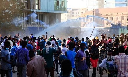 <p>Sudanese security forces use water cannons and teargas against protesters in the capital Khartoum on December 25, 2021, during a demonstration demanding civilian rule. - Thousands of Sudanese protesters rallied two months after a military coup, demandi