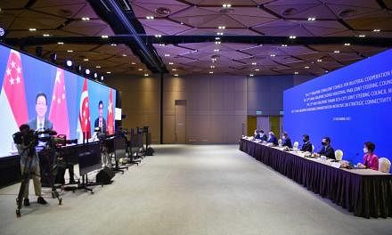 (From left) Dr Tan See Leng, Lawrence Wong, S Iswaran, Dr Vivian Balakrishnan, Chan Chun Sing, Desmond Lee and Low Yen Ling at the 17TH JOINT COUNCIL FOR BILATERAL COOPERATION AND RELATED JOINT STEERING COUNCIL MEETINGS and on screen is Han Zheng, Vice-Pr