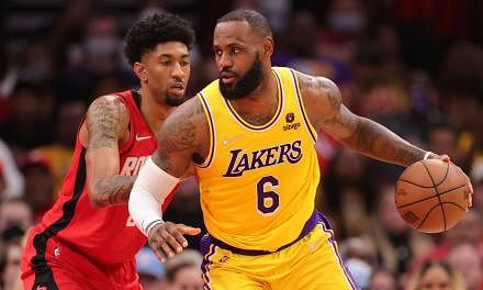 Los Angeles Lakers'  LeBron James (right) ahead of Houston Rockets' Christian Wood at Toyota Center on Dec 28, 2021.