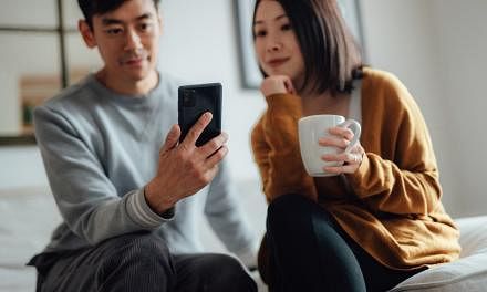 A man and woman investing digitally