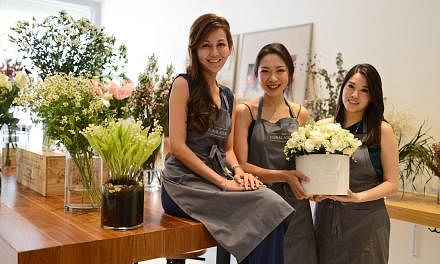 Mrs Fiona Treadwell uses succulents, herbs and fruit in her arrangements. Old-timer Floral Magic is now helmed by two generations and has gone the indie route. (From left) Ms Patricia Low, Ms Joanna Teo, Ms Linnette Lau, Ms Josephine Lau and Ms Lucy 