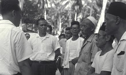 Mr Othman touring the Mountbatten area - where he met leaders of the goodwill committee - as part of efforts to restore racial harmony after the July 1964 racial riots. Above: Minister for Social Affairs Othman Wok accompanying Prime Minister Lee Kua