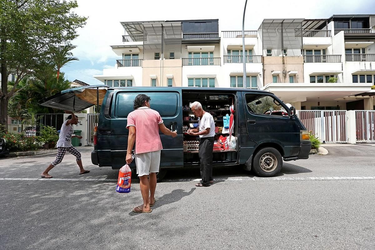 Mr Foo knows some of the domestic helpers who work in houses along his regular route so well that he lets them open the doors of his 17-year-old Toyota HiAce and collect the groceries they want themselves. Mr Foo takes a break at home after his morni