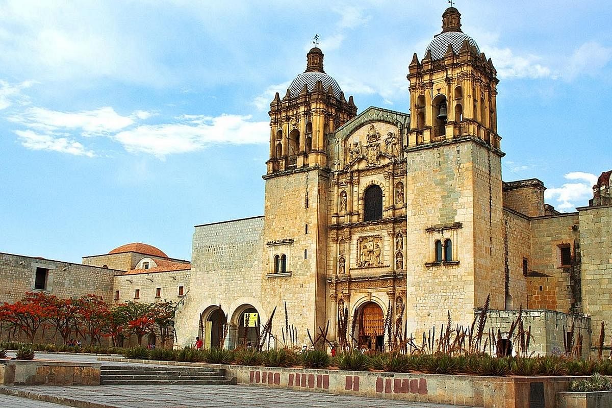 Construction of the baroque church, Templo De Santo Domingo De Guzman (above), began in the 16th century and took more than 100 years to complete. A vendor sells chapulines or fried grasshoppers (right). A farmer harvests agave plants (far left), whi