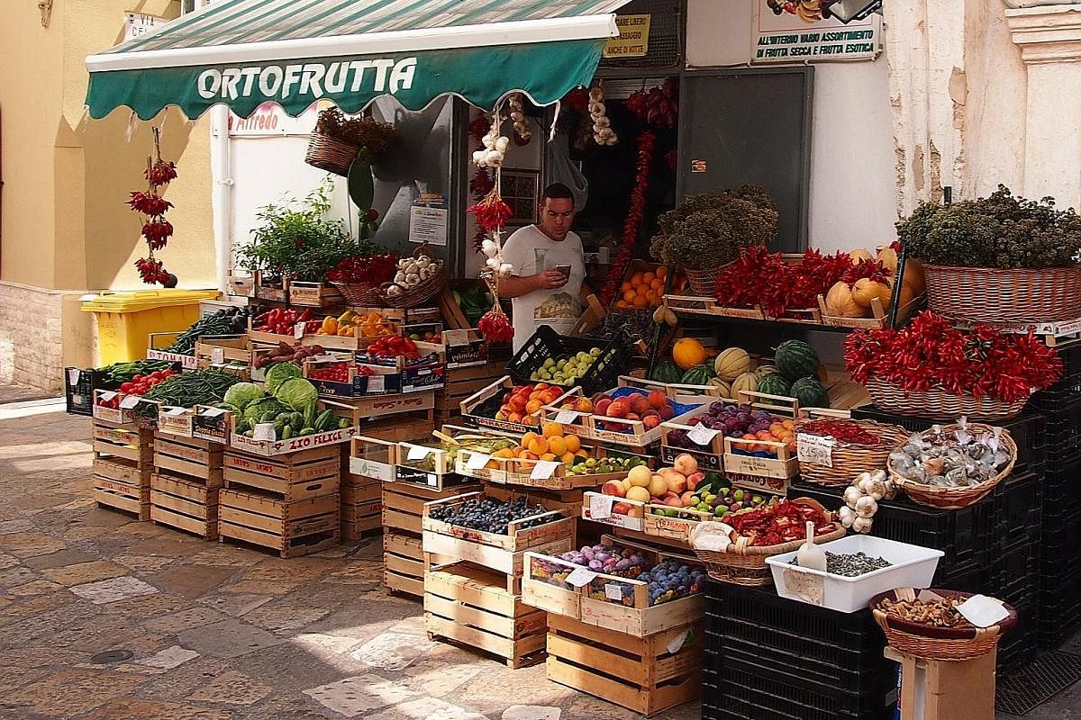 The Piaggio Ape, a lightweight, three-wheel truck that is to the Italian countryside what the Vespa is to its cities. Fresh fruit and herbs for sale at a corner store in Gallipoli. In the summer, the winding streets of Alberobello are filled with tou