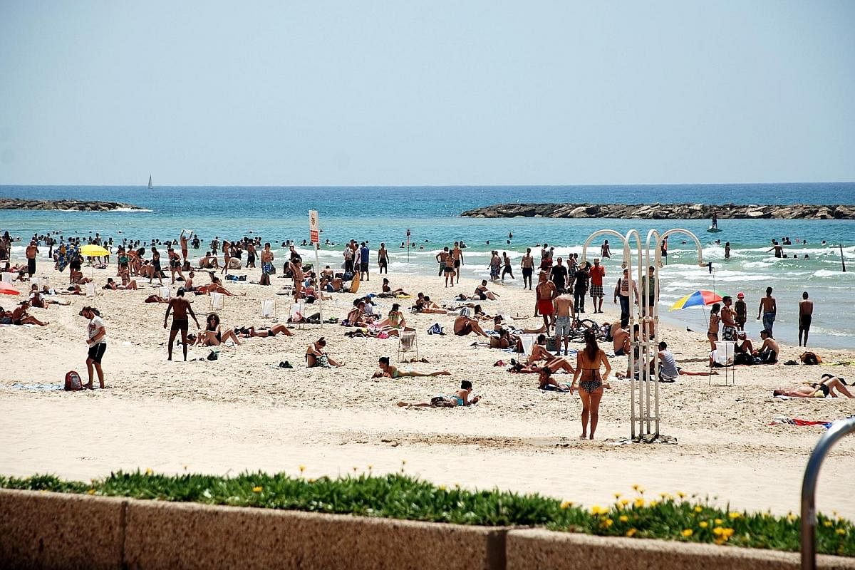 Tel Aviv sits on the Mediterranean coastline and boasts a dozen beaches, where Israelis love to relax.